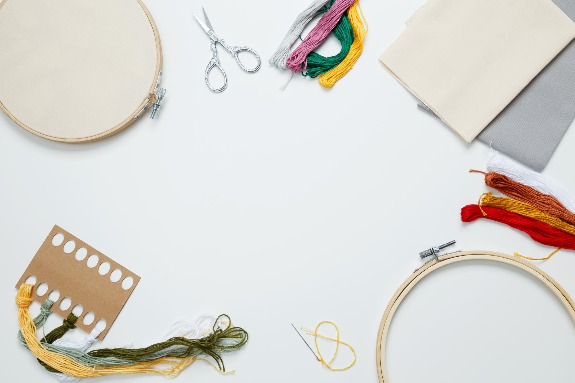 Workshop desktop with threads and embroidery hoop